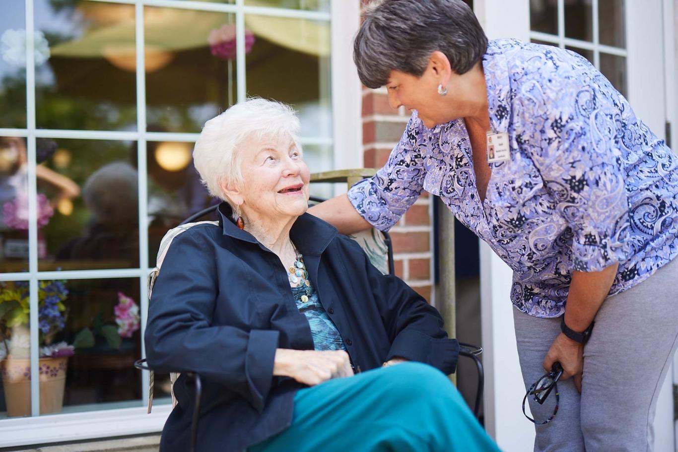 Caregiver helping woman outdoors