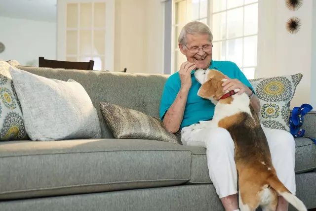 Senior man playing with dog