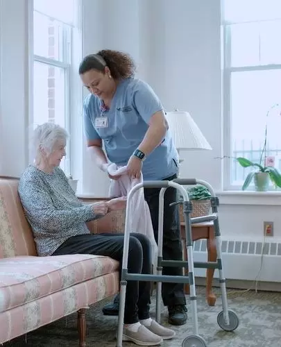 Caregiver helping senior woman