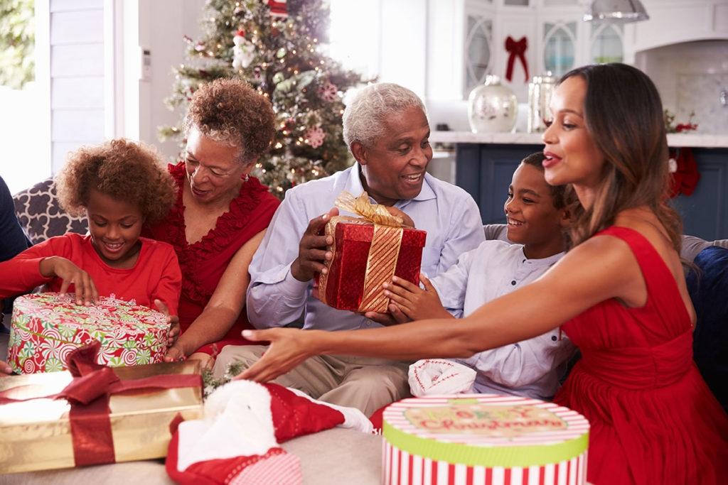 A multi generational family opening presents at Christmas