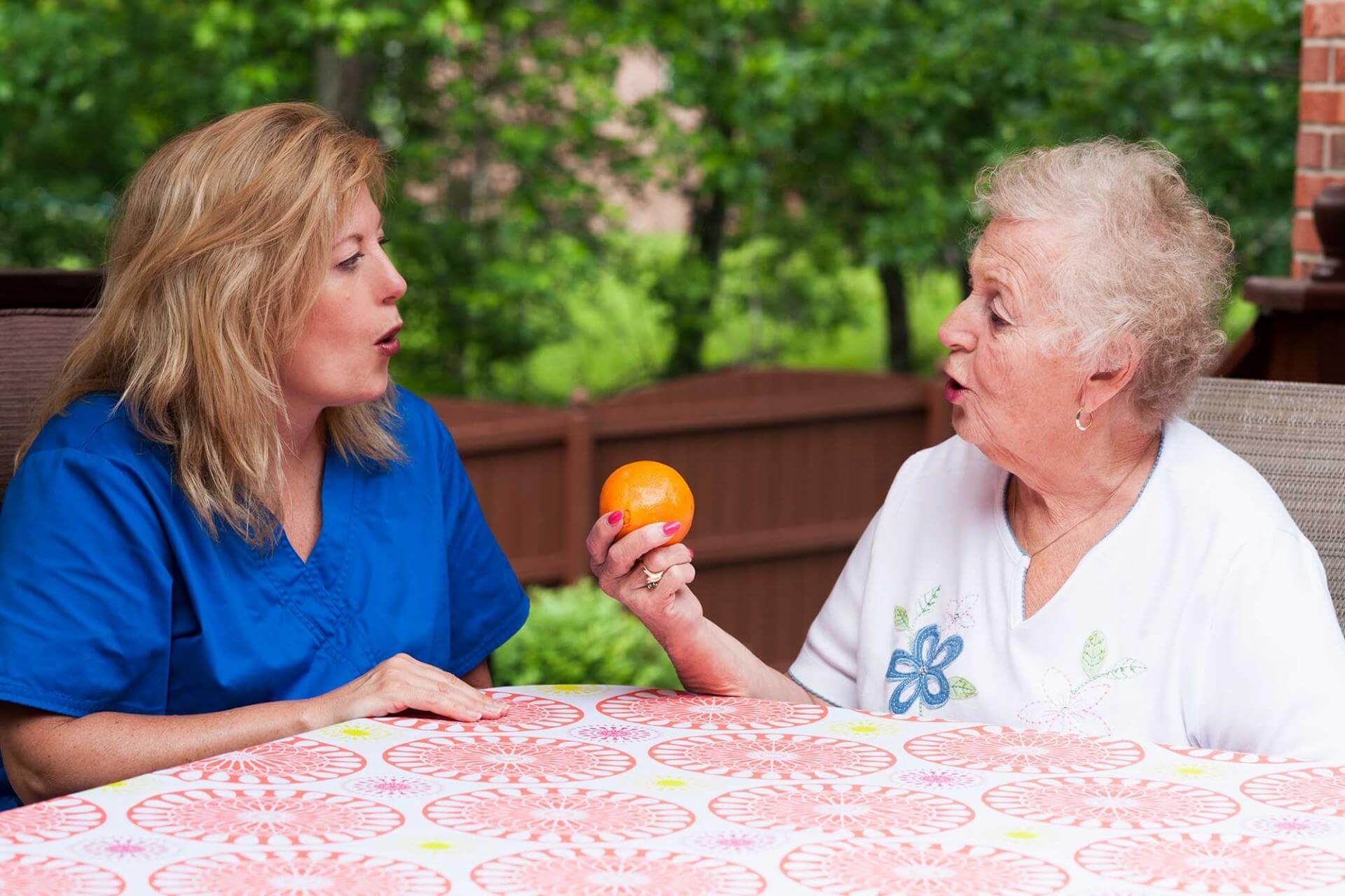 Senior woman and staff member doing occupational therapy