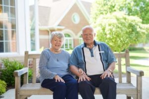 Senior couple posing for photo outdoors