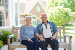 Senior couple posing for photo outdoors