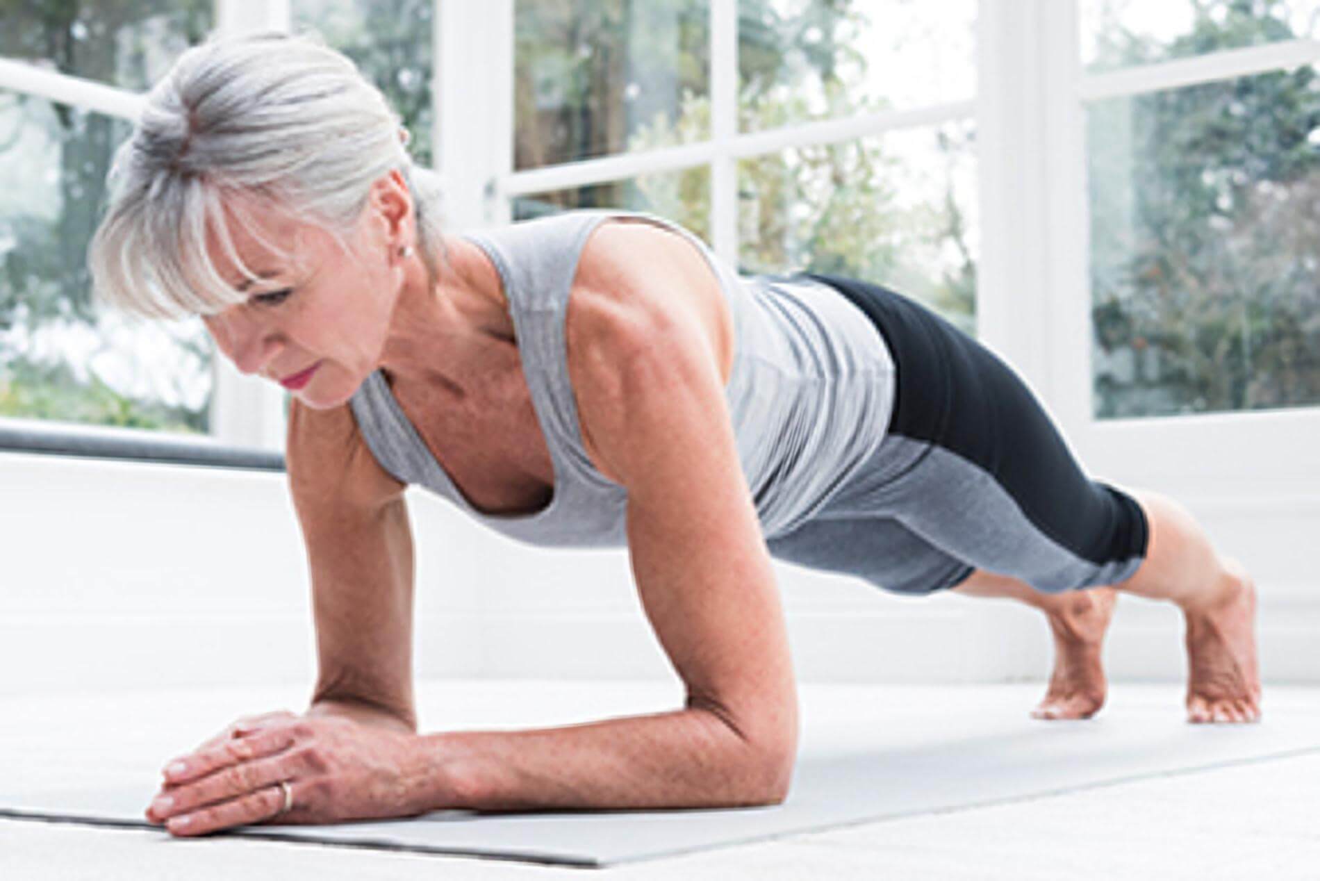 A senior woman practicing pilates