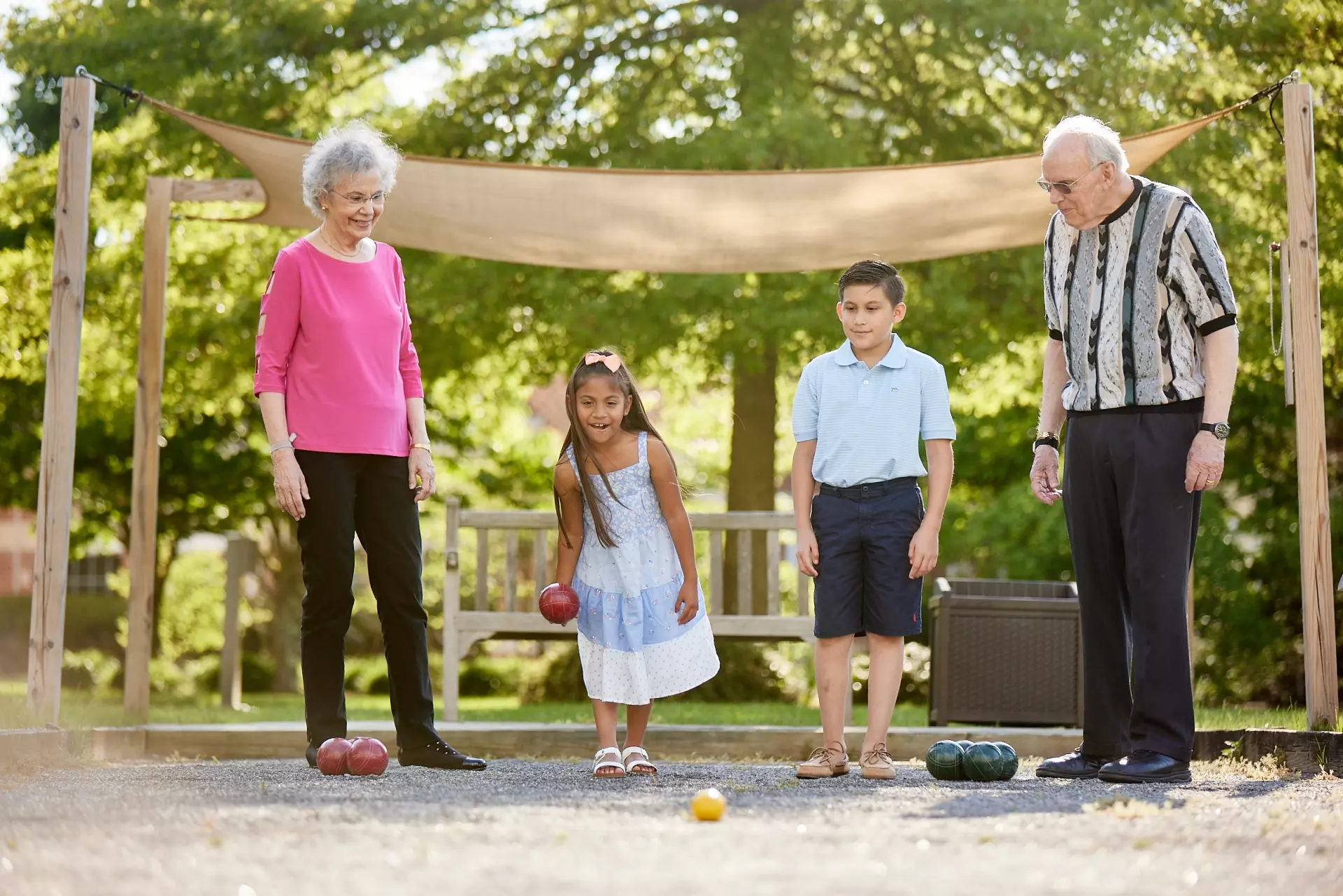 Grandparents and grandchildren playing bocce
