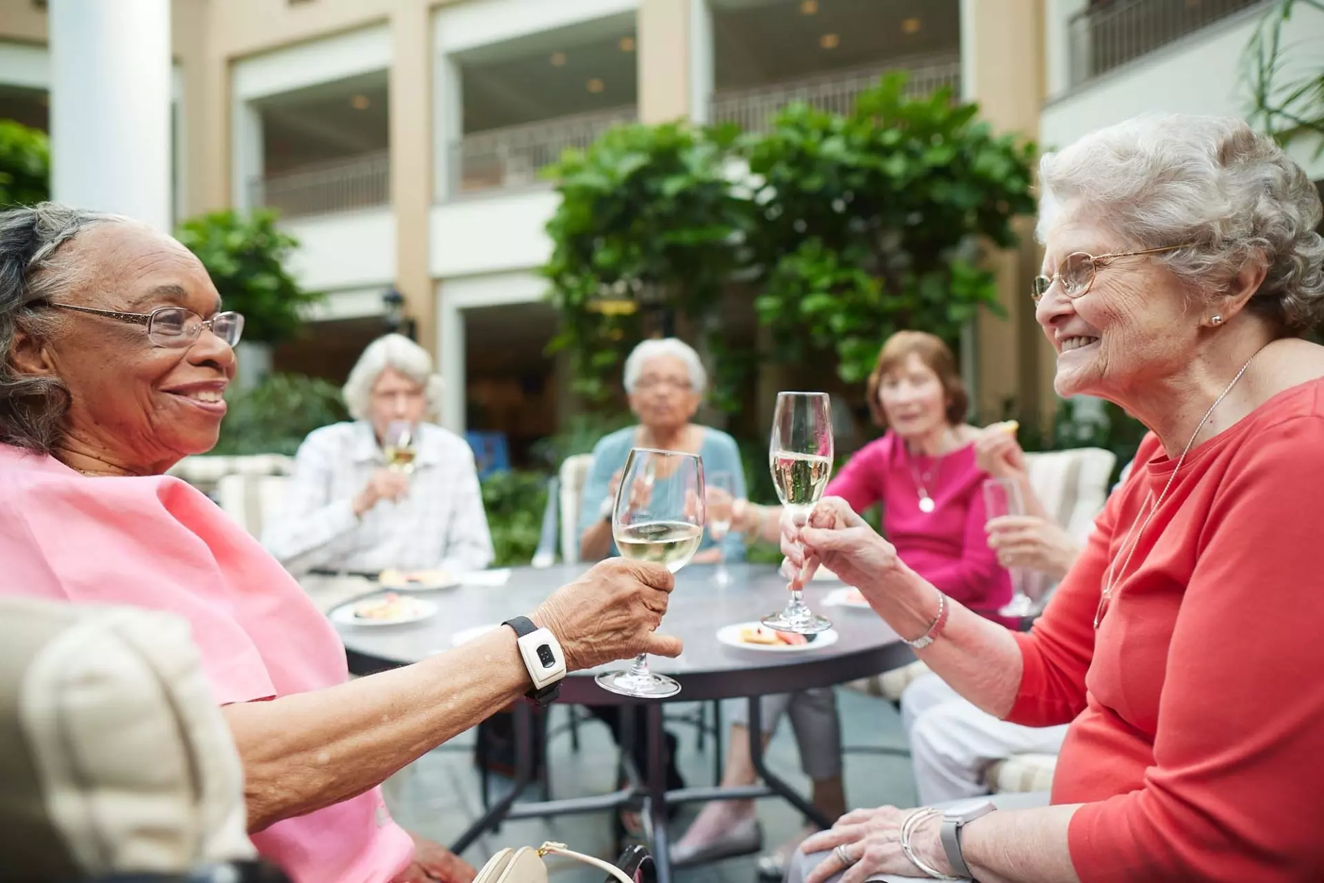 Senior woman toasting drinks