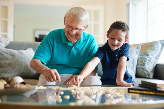 Grandfather and grandson doing puzzle