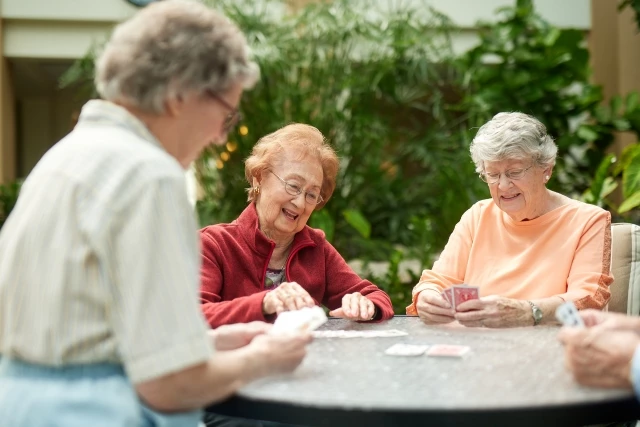 Senior women playing cards