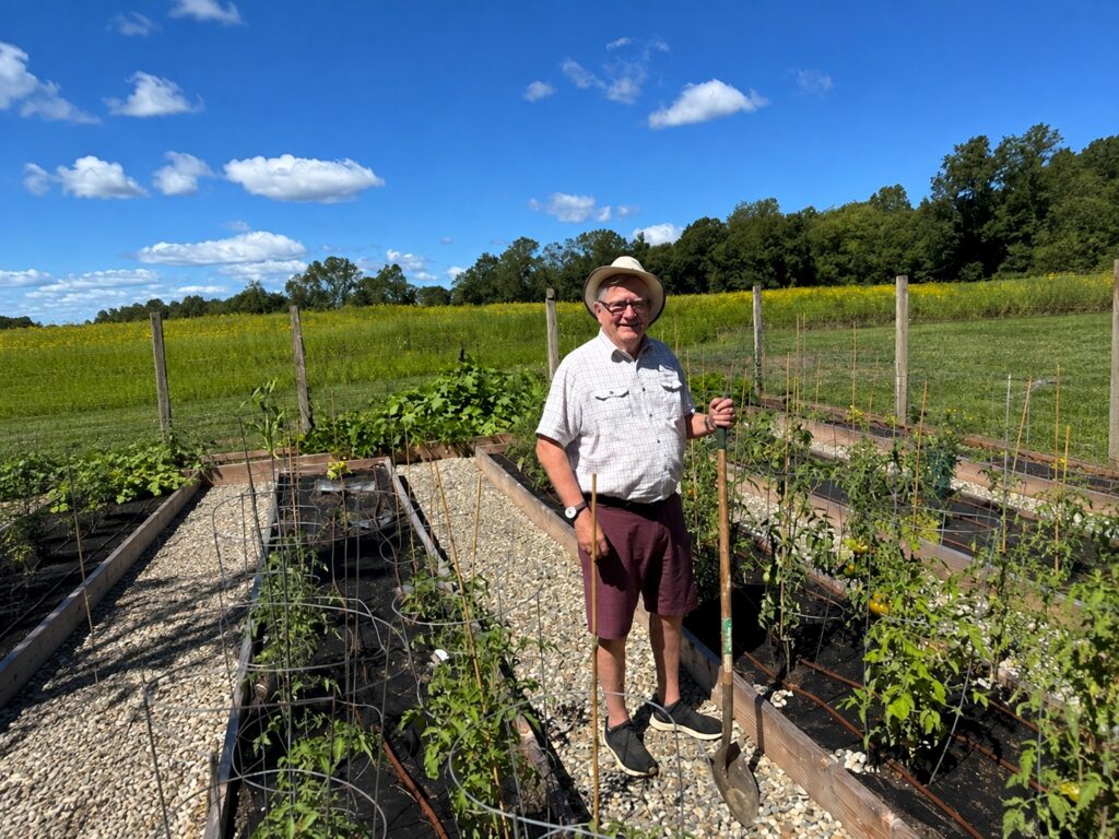 Meadow Ridge resident Doug D. tends vegetables and herbs at The Farm, where residents plant, water and harvest produce that is shared and used in Chef Tom Villa’s culinary creations.