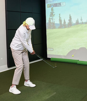 Resident using golf simulator