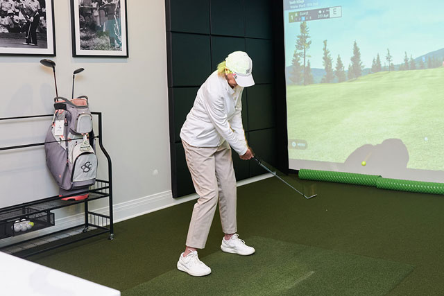 Resident using golf simulator