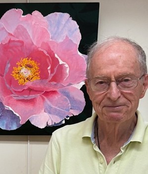 Ed alongside one of his watercolor paintings displayed at Meadow Ridge.