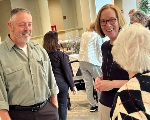Patrick Boelens, Meadow Ridge’s new Plant Operations Director, speaks with two residents during a Mix and Mingle social in the Atrium.