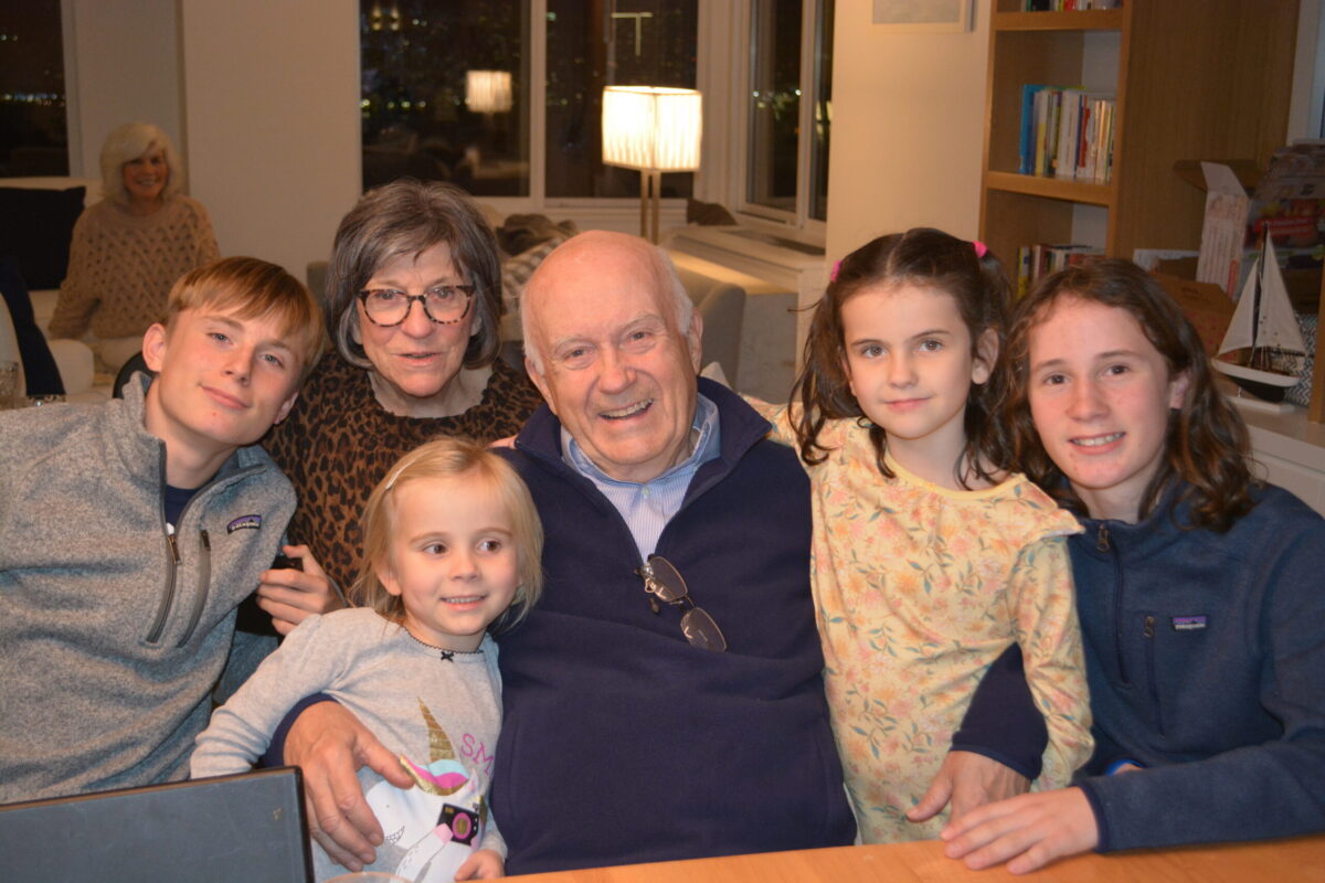 Dick and Lois S. smile with their four grandchildren during a family gathering.